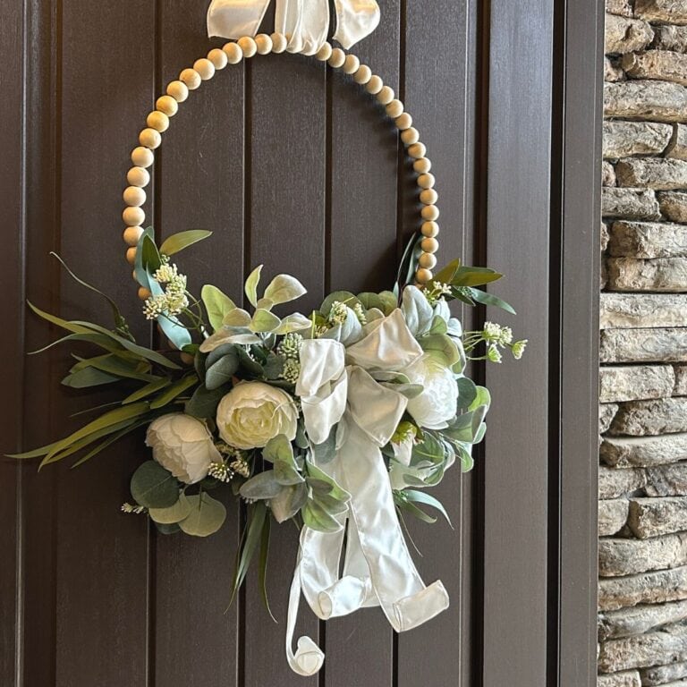 wood bead wreath with flowers and bow