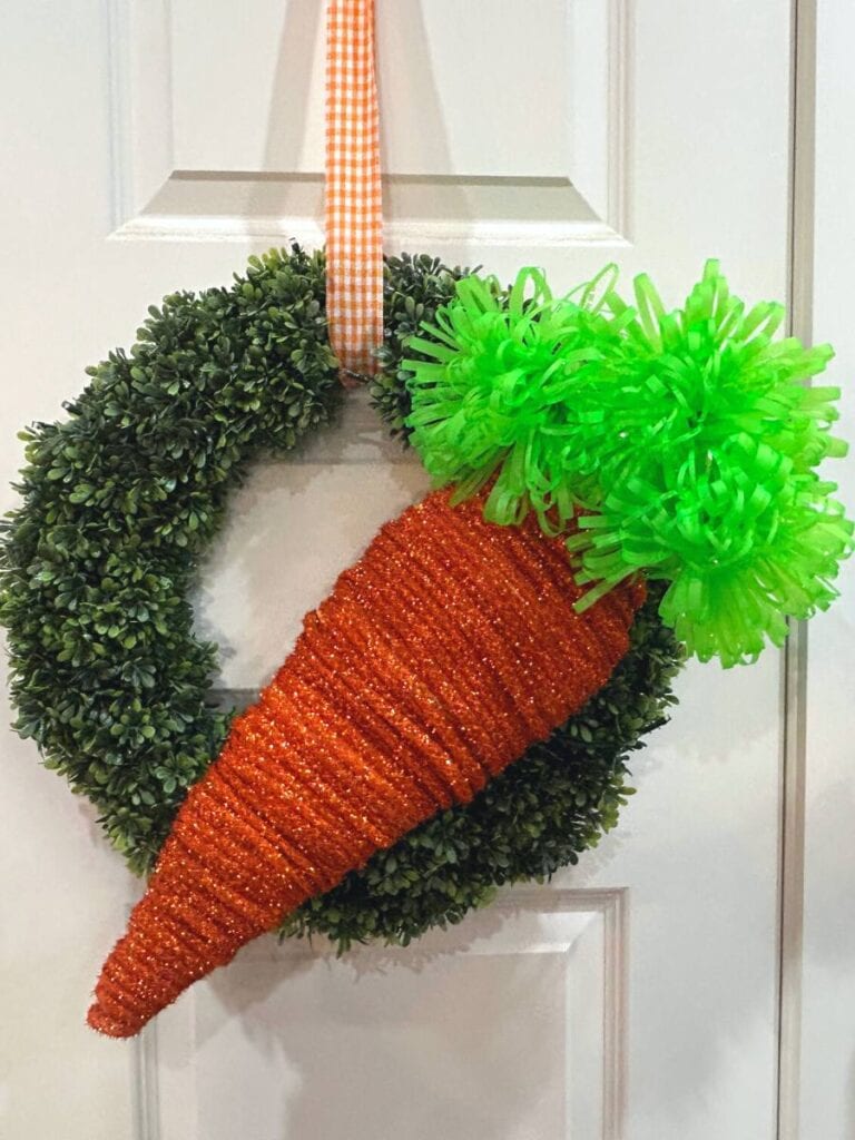 boxwood wreath with a large DIY easter carrot made with deco flex tinsel tubing