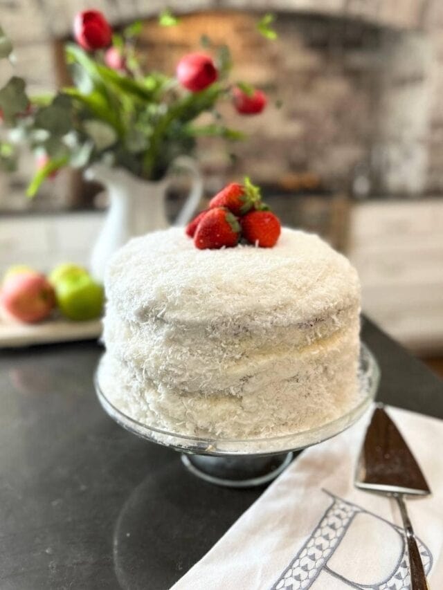 fresh coconut cake with strawberry garnish