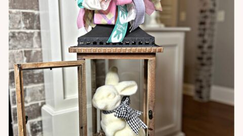 flocked bunny in a lantern with funky bow on top made from six different ribbons