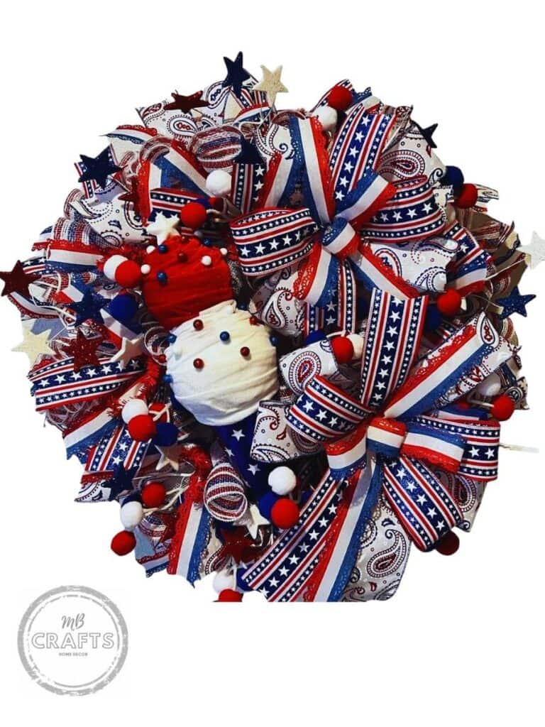 patriotic wreath made with deco mesh, ribbons, star sprays and ball picks