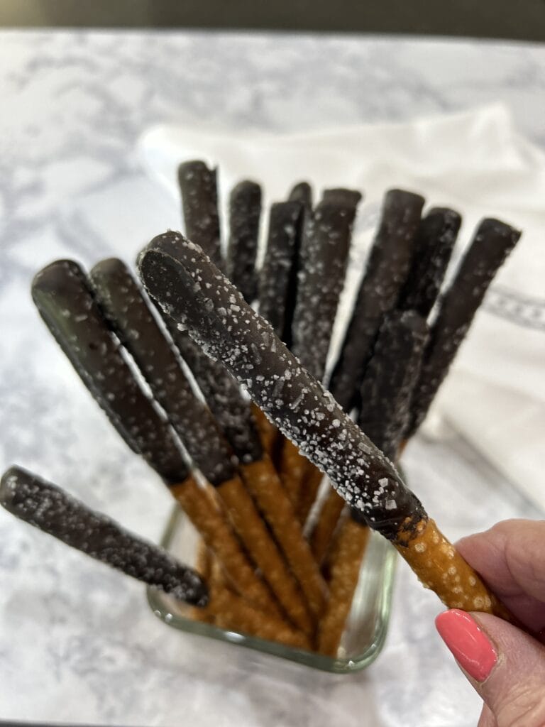 pretzel sticks dipped in hot chocolate and sprinkled with kosher salt