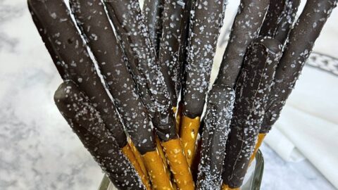pretzel rods dipped with dark chocolate with sea salt sprinkles