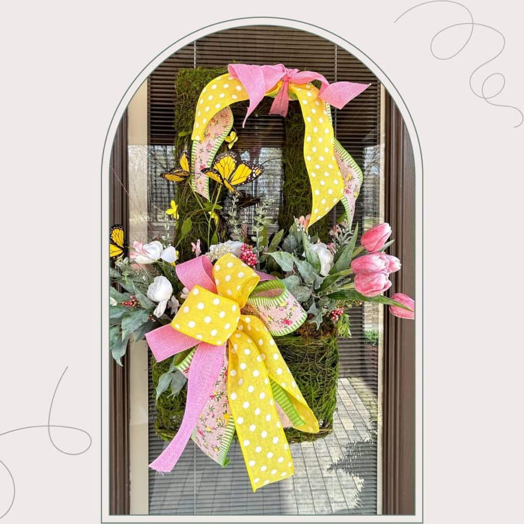 mossy wall basket filled with spring blooms, tulips, ranuculus, butterflies, ribbon