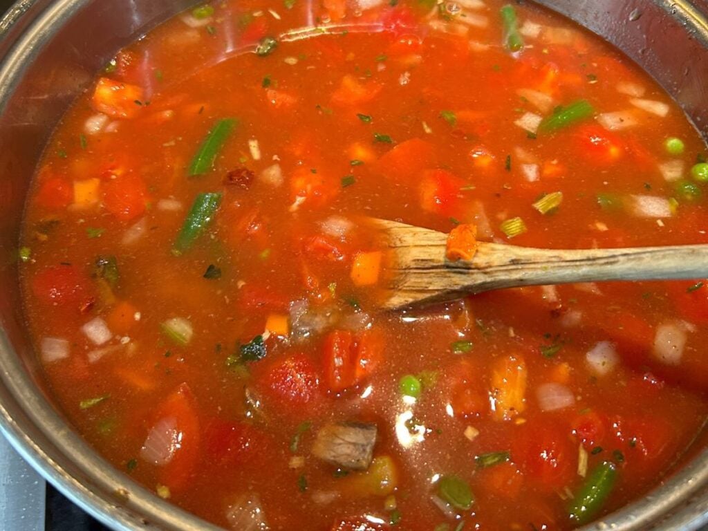 homemade vegetable beef soup simmering on the stove