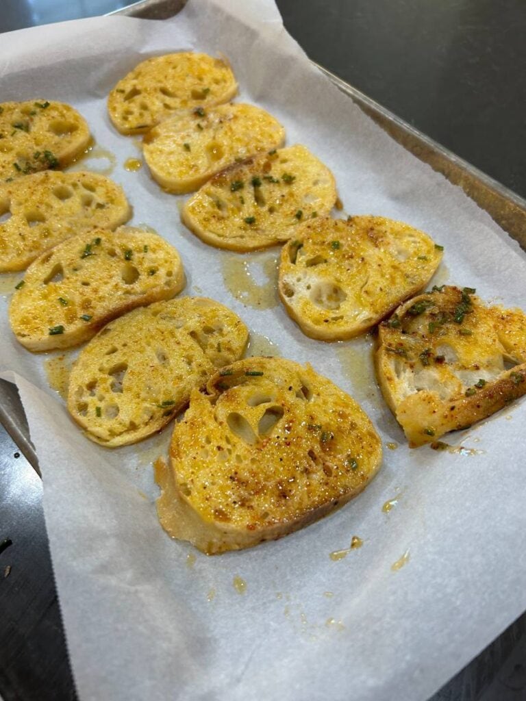 bake bread on parchment paper in a slow oven until brown and crisp