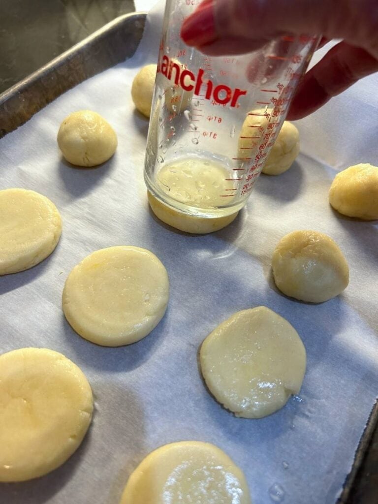 flatten dough balls with a moistened glass for lemony sugar cookies