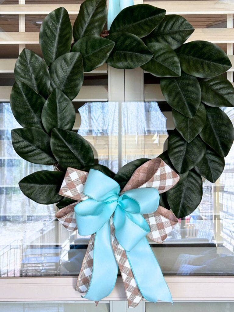 spring update for a mangolia wreath with a new beige white, blue bow