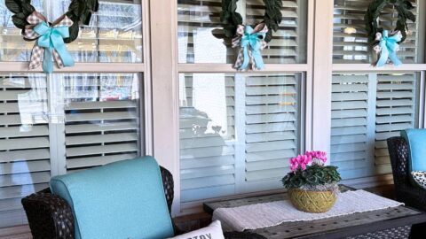 back porch Magnolia wreaths updated with new bows for spring to match chair cushions