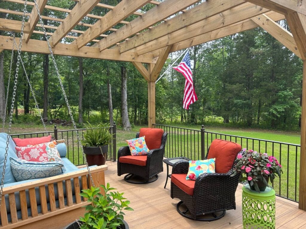 back porch or deck with porch swing and american flag hanging