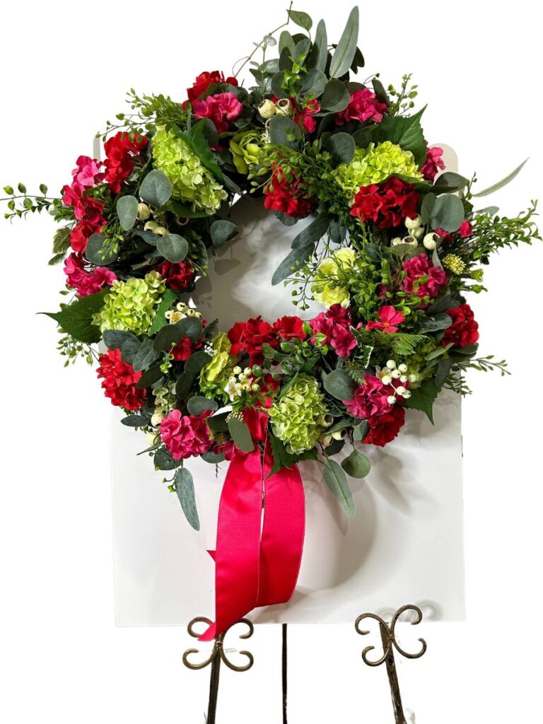grapevine wreath tutorial with eucalyptus, boxwood, lime hydrangeas, deep pink and red geraniums, picked on a work board