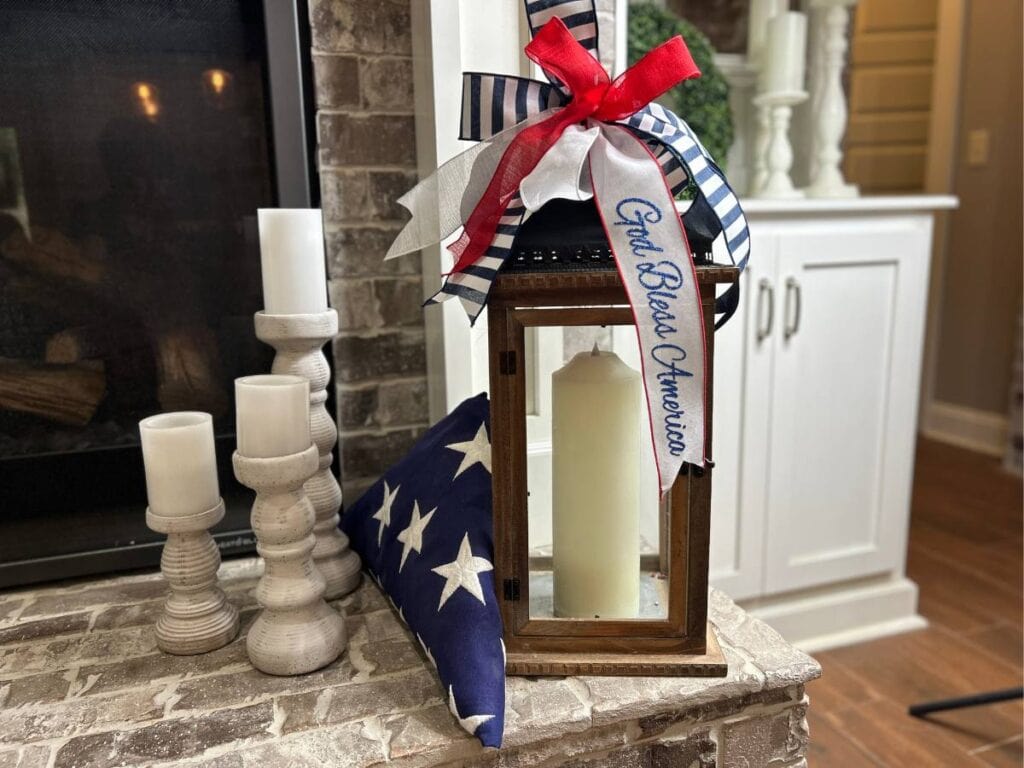 patriotic decoration for a lantern beside a folded flag on a hearth