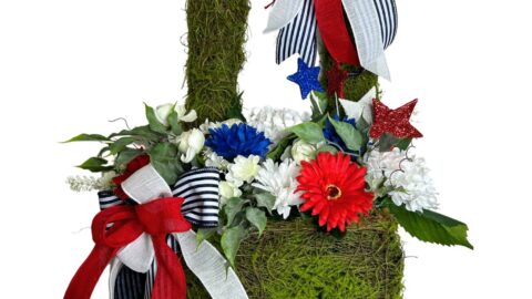 moss basket with red, white, and blue flower, greenery and simple patriotic bow