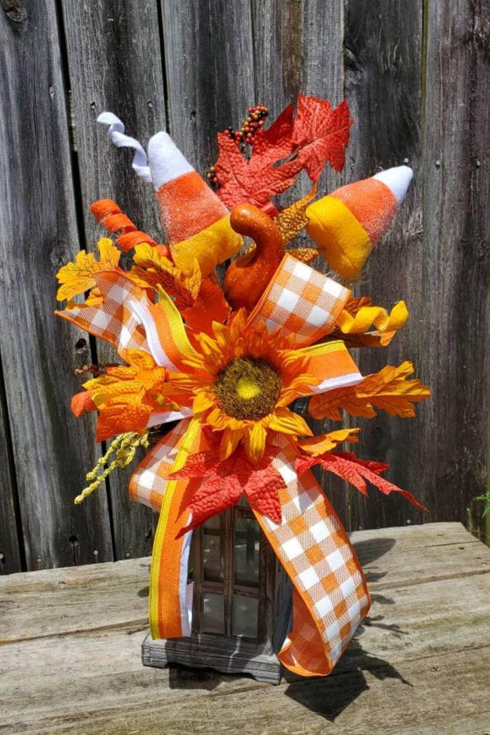 lantern with a candy corn decorations design, sunflowers and big checked bow