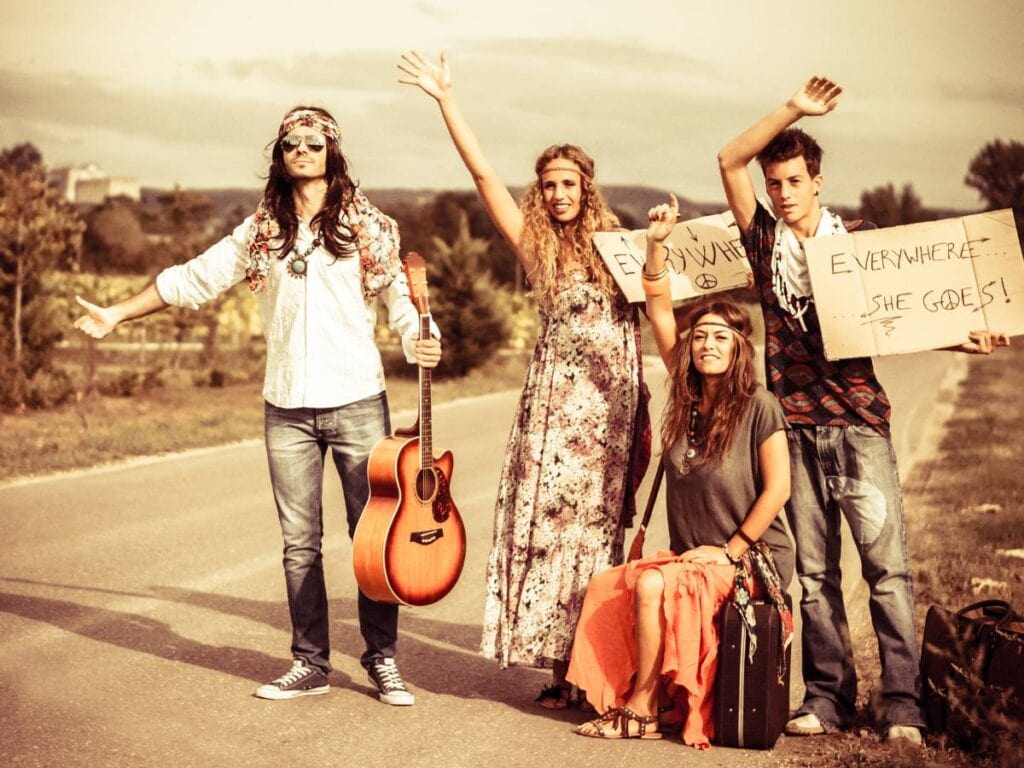 hippies holding signs and hitch hiking