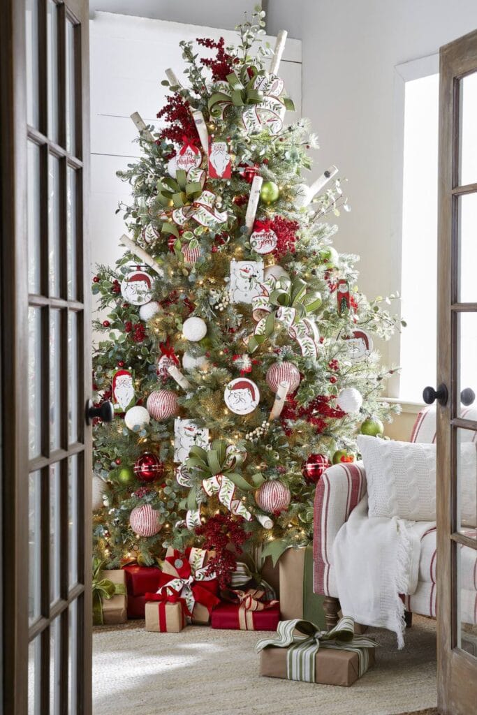 christmas tree with holly ribbon, striped balls, holly berries, santas and snowmen
