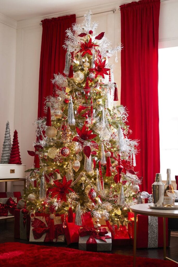 christmas tree with vintage silver tassels, bold red poinsettias red tassels, silver garlands