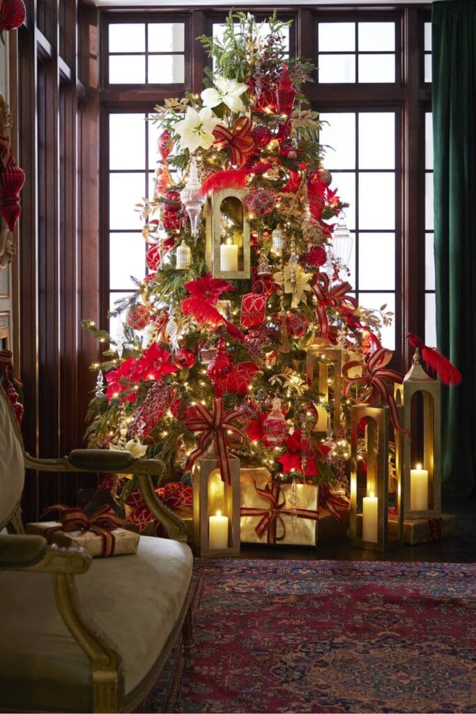 classic red and gold christmas tree with red poinsettias, white poinsettias, crystal ornaments