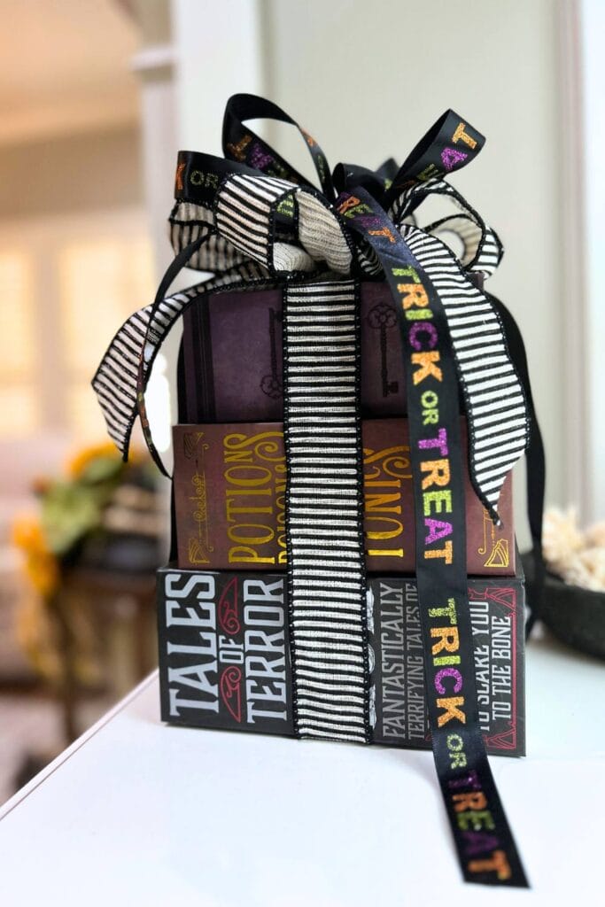 stack of halloween boxes tied with a bow from the dollar store