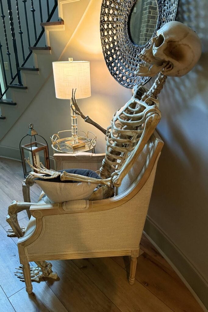 lifesize skeleton sitting in a chair