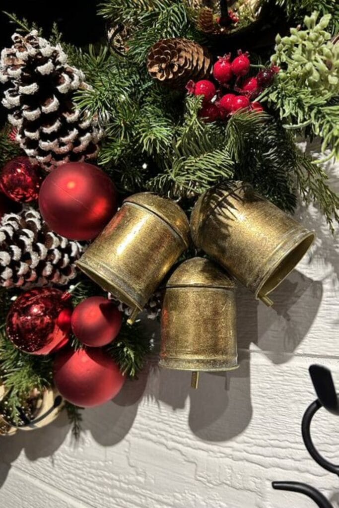 antique gold bells, frosted pinecones, red berries and evergreen