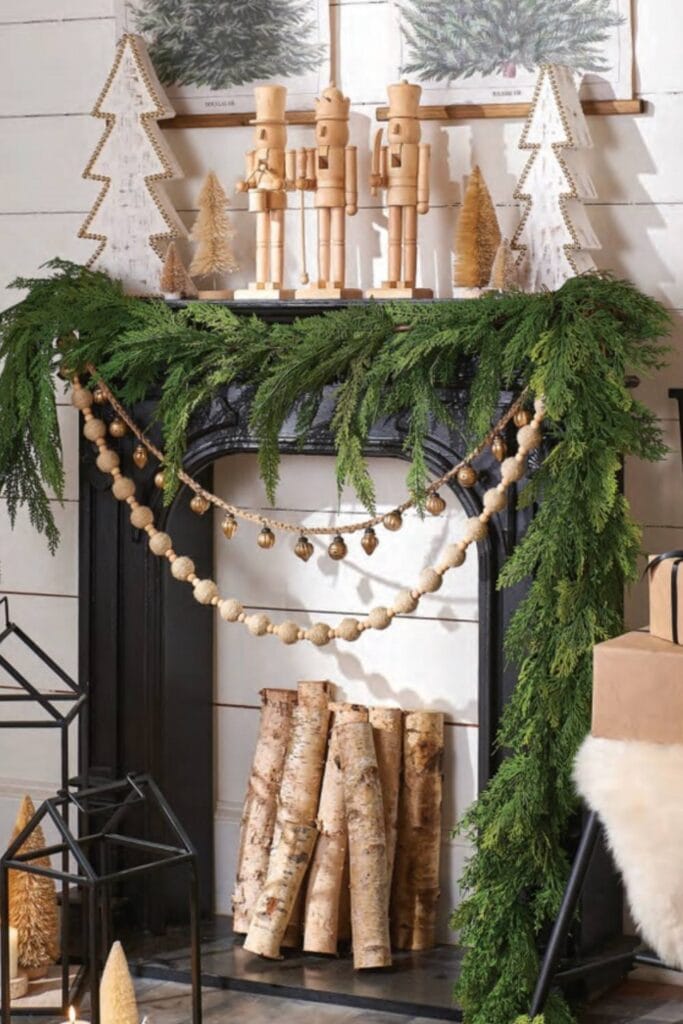 mantel decoration idea from the All is Calm collection from RAZ, cedar garland, wood beed garlands and plain wood nutcracker accents