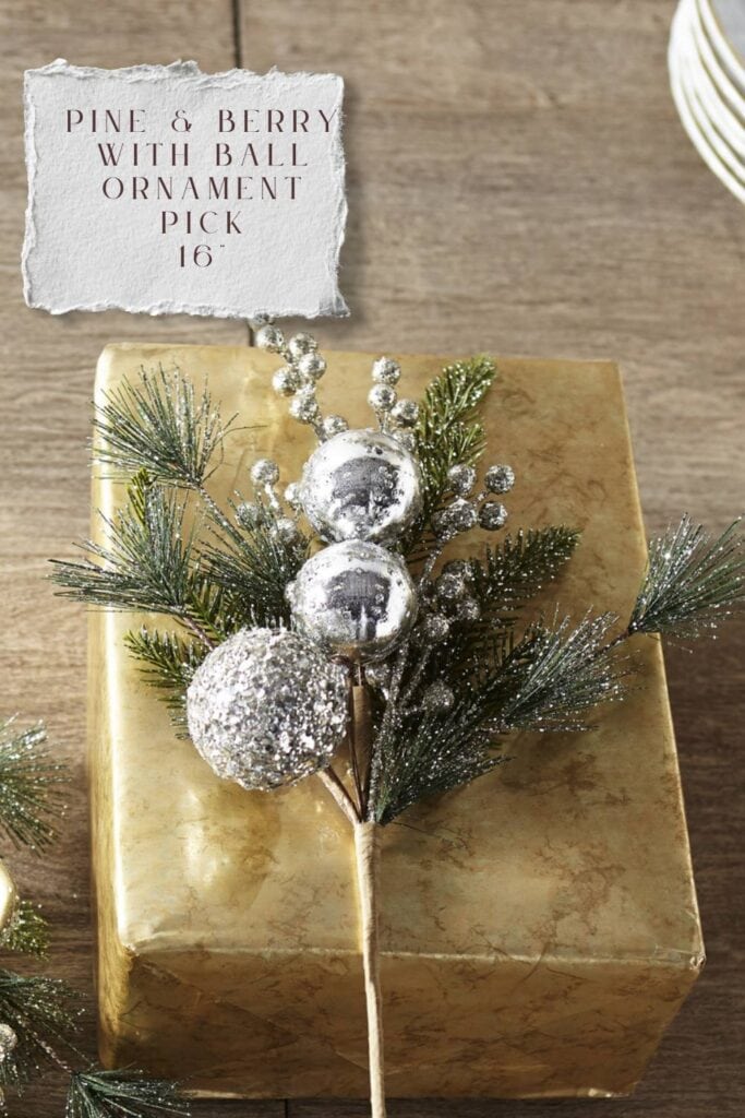 icy silver ball ornament with greenery twig christmas decoration