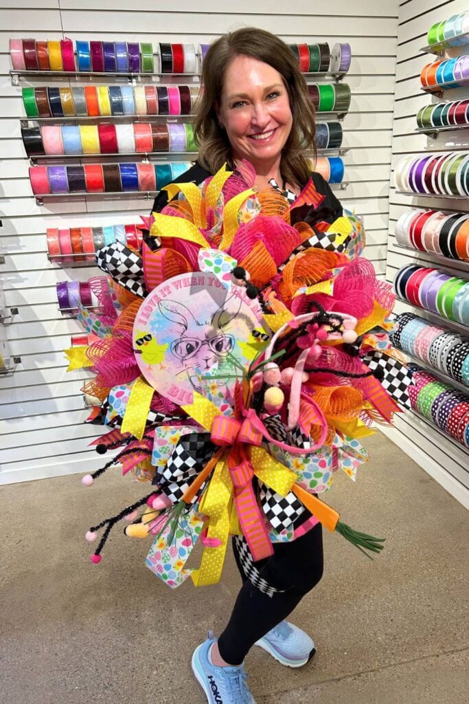 DIIY easter wreath with mesh, ribbon, a metal sign on a pink wreath form