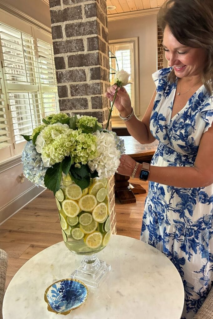 carrie arranging fresh flowers in a lemon lime vase