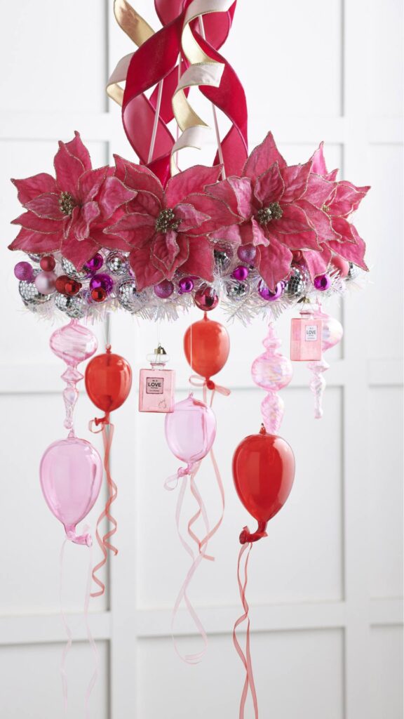 hanging chrismtas chandelier with pink poinsettias and ribbons