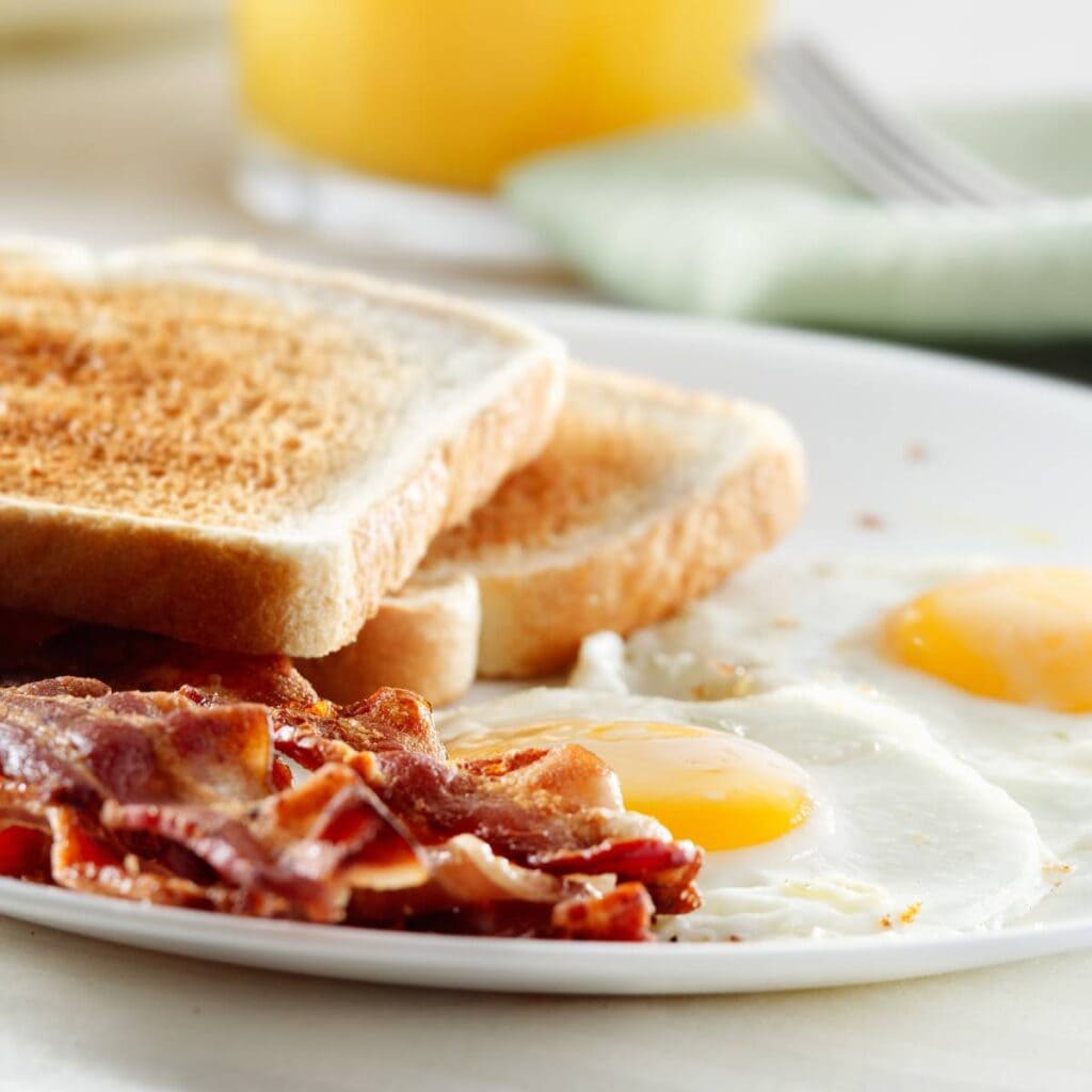 breakfast with bacon, eggs, and toast