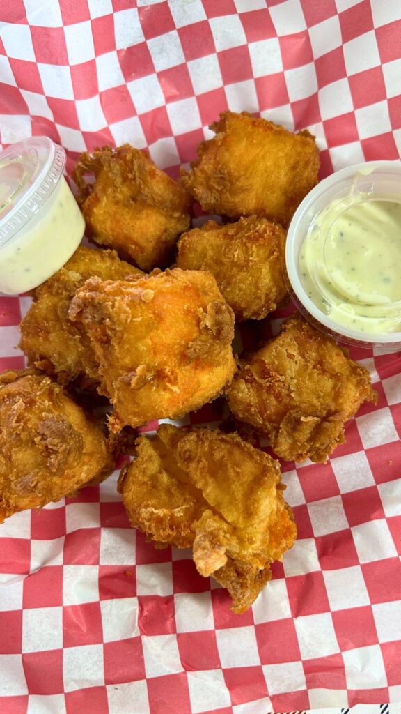 hoop cheese bites, pieces of fried cheese as an appetizer with Ranch dressing at Toccopola Grocery