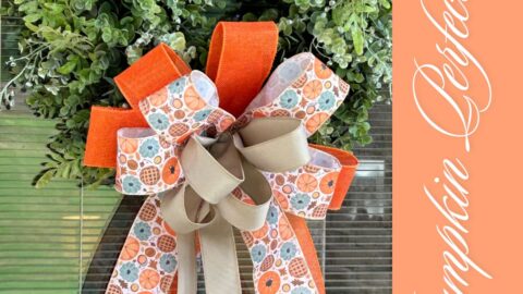 fall bow for a boxwood wreath in orange, pumpkin print and taupe ribbons