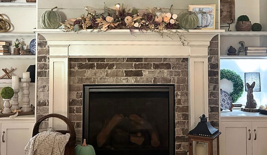 mantel and bookcases with fall floral arrangement