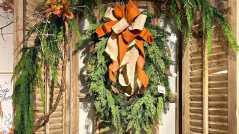 rustic window decor, mixed pine and cedar wreath, natural branches, and rust and beige ribbon