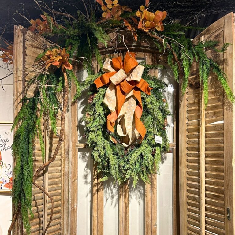 rustic window decor, mixed pine and cedar wreath, natural branches, and rust and beige ribbon