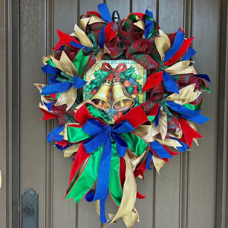 red, green, gold, and blue deco mesh Christmas wreath with an exclusive Trendy Tree jingle bells stained glass look metal sign