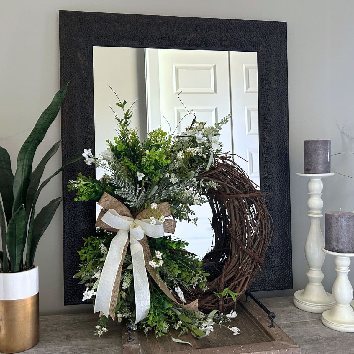 spring wreath decor, wreath positioned in front of a mirror for a fresh look