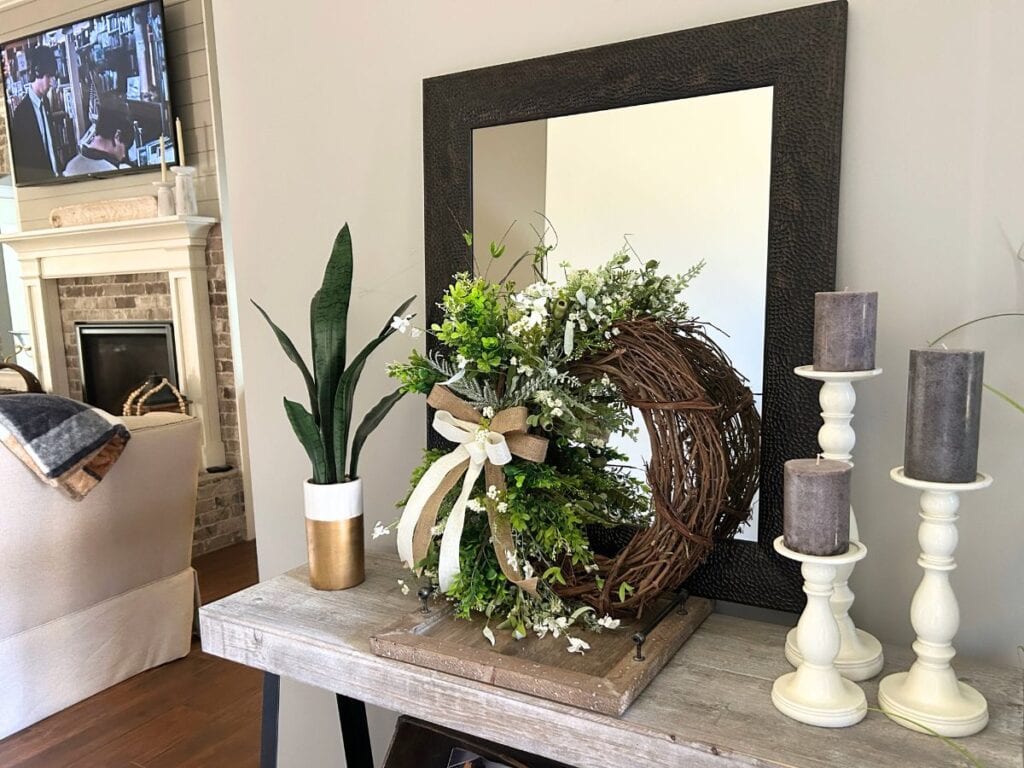 g wreath decor, wreath positioned in front of a mirror for a fresh look
