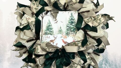 cream mesh wreath with dark green ribbons and an exclusive Trendy Tree winter wildlife sign