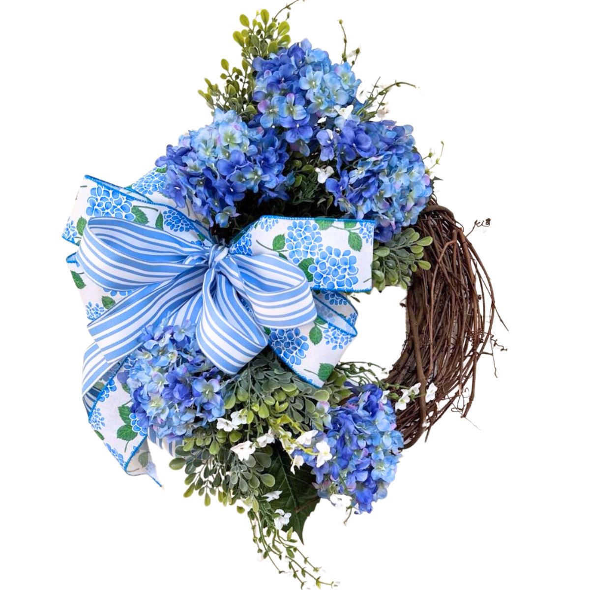 grapevine wreath with blue hydrangeas, greeneryi and a bow