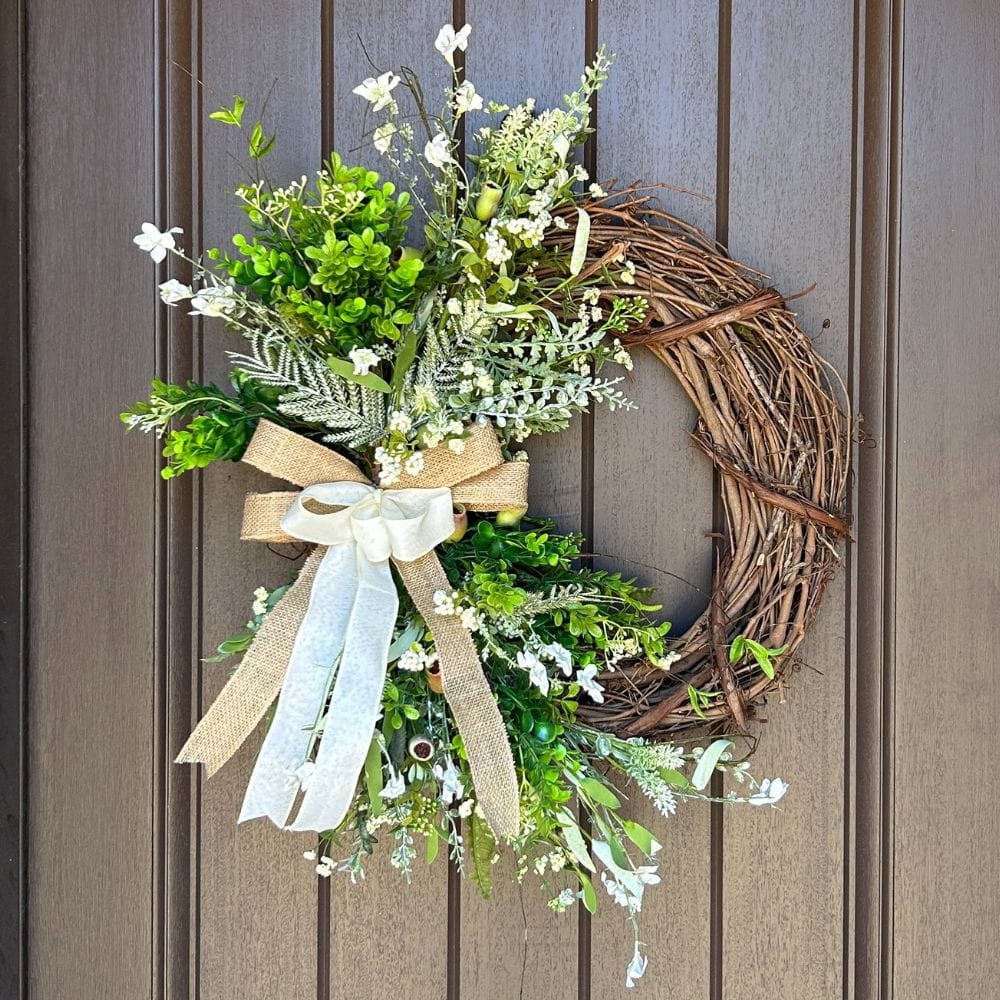 grapevine wreath with spring florals and simple neutral bow