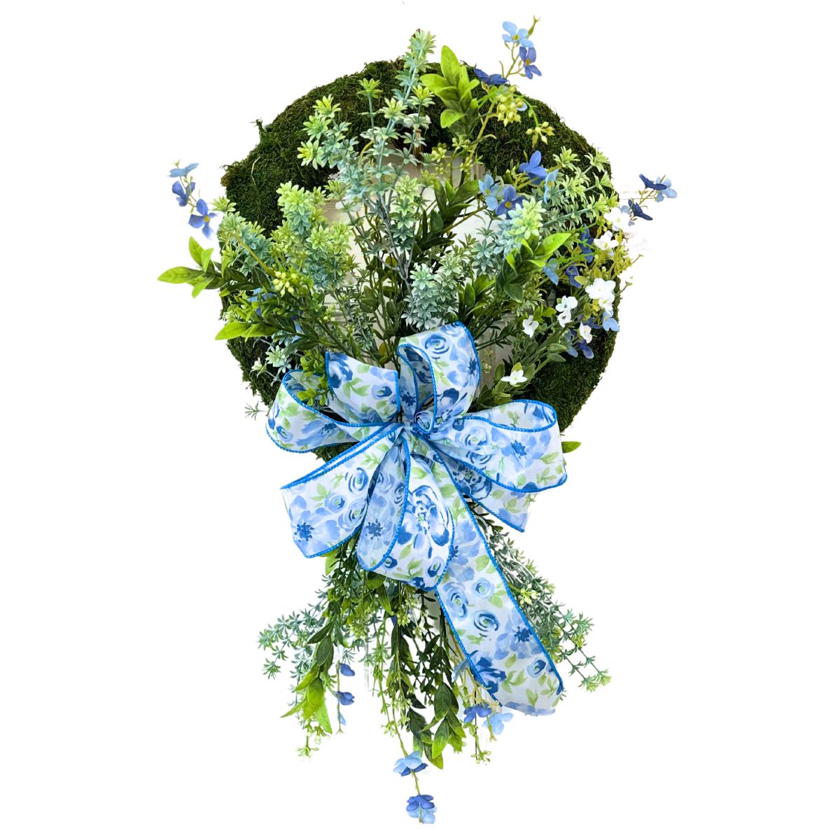 spring wreath on a moss wreath base with blue and white floral ribbon