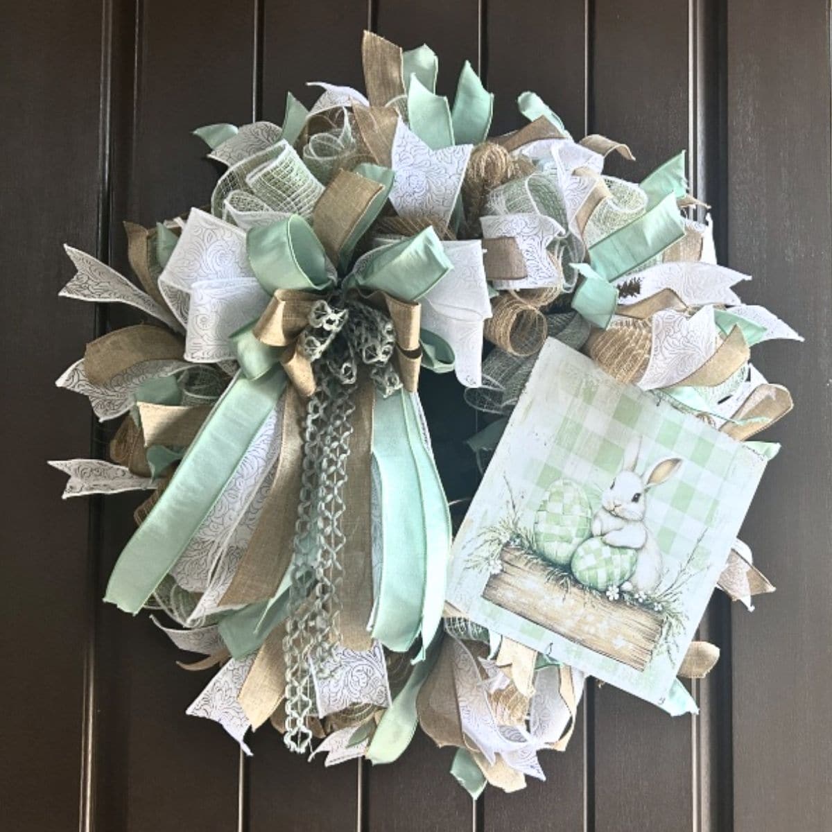 sage green mesh Easter wreath with an exclusive Trendy Tree bunny sign