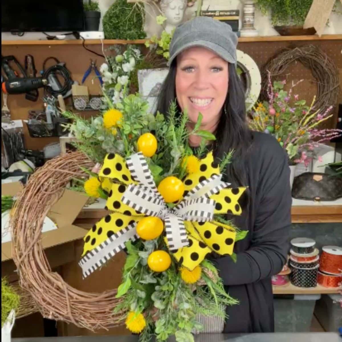 grapevine wreath decorated with lemons, greenery, yellow flowers and pretty bow