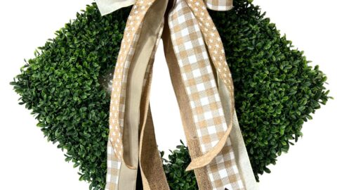 neutral bow for a square boxwood wreath hung as a triangle
