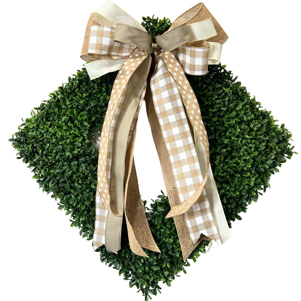 neutral bow for a square boxwood wreath hung as a triangle