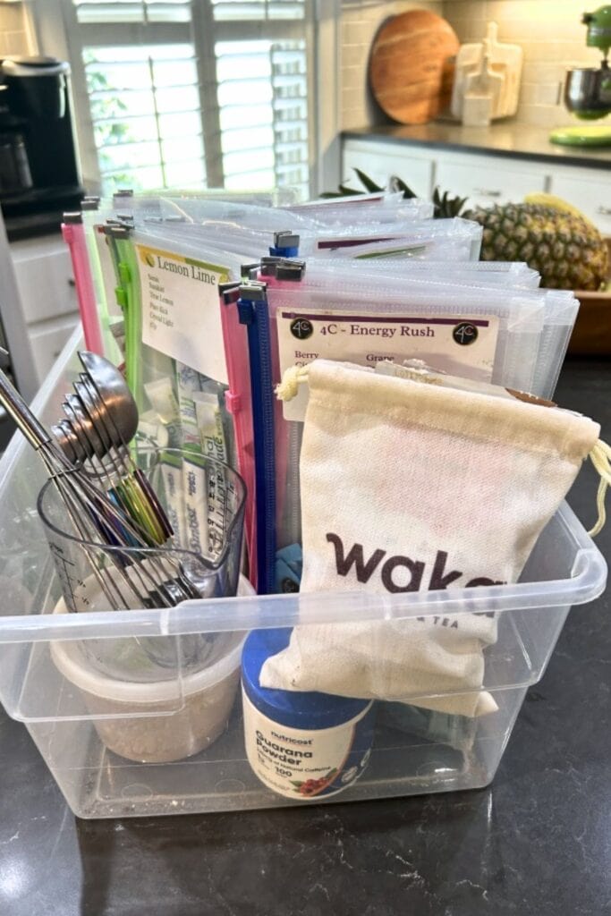 collection of loaded tea mixes, measuring spoons and cups, plastic pouches for holding drink mixes