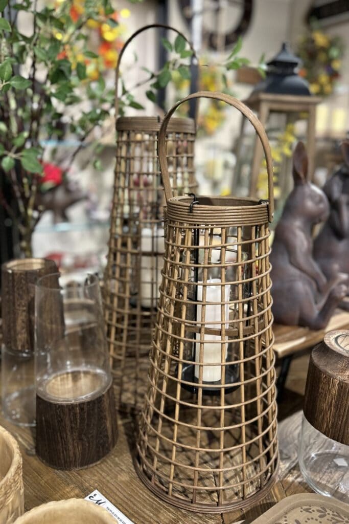 brown wicker style lanterns with suspended candles perfect for covered porches or patios as a spring summer lantern decor
