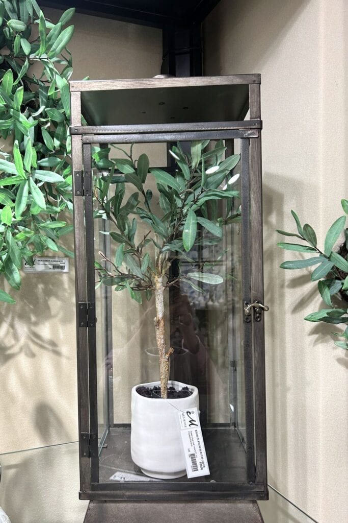 tall metal lantern with faux potted plant